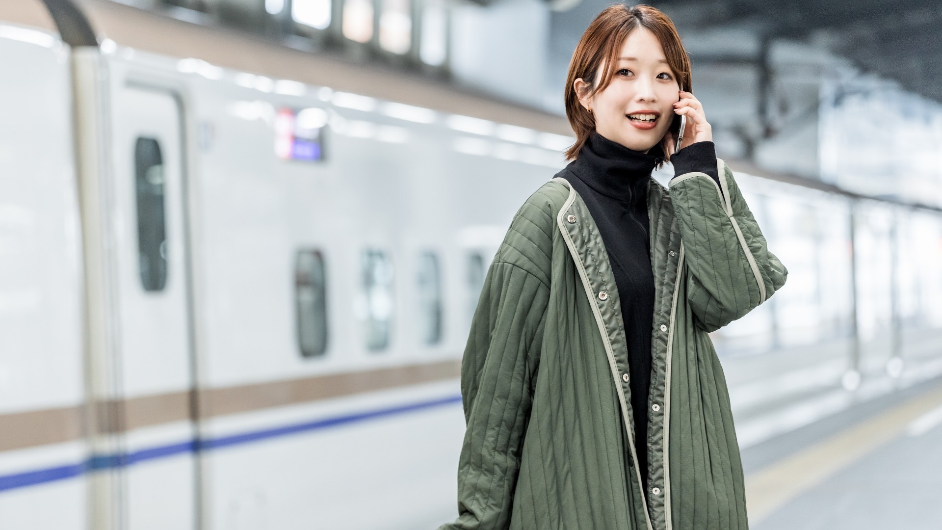 新幹線ホームで一人旅をする女性